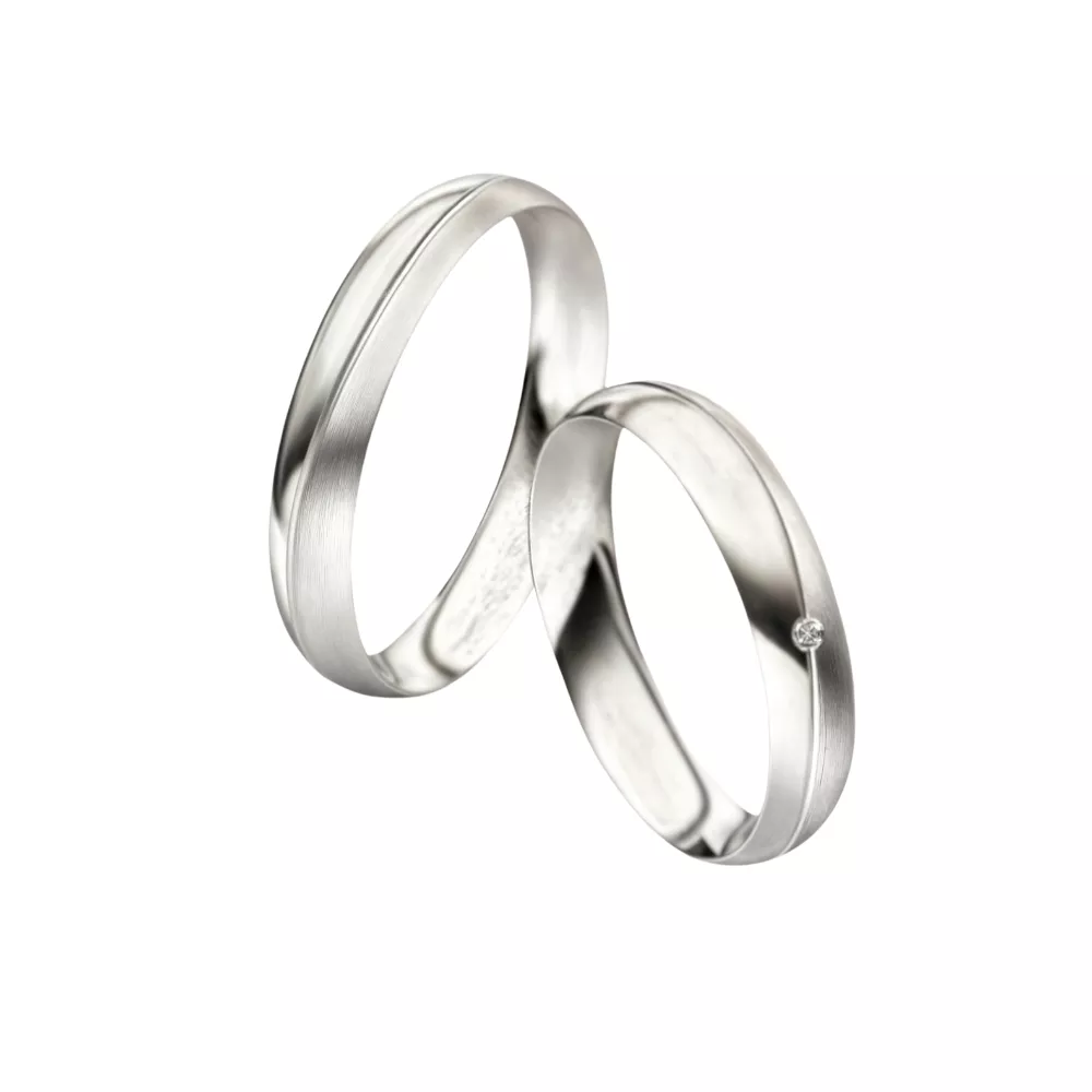 Alianzas en oro blanco pulido y arenado con 1 diamante talla brillante. Espesor: 4 mm. Peso total: 9 gr. 
