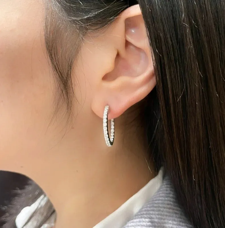 Hoop earrings in platinum set with brilliant-cut diamonds.