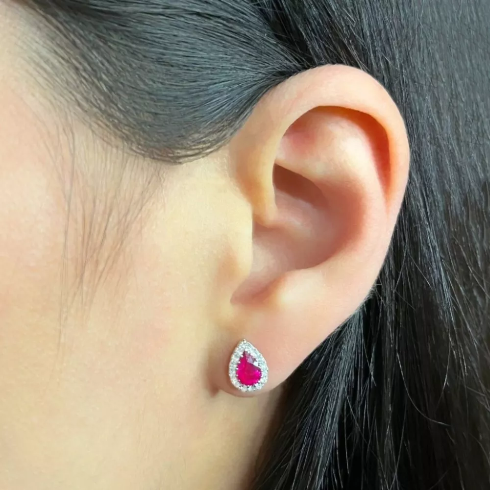 Earrings in white gold set with pear-cut rubies and brilliant-cut diamonds.