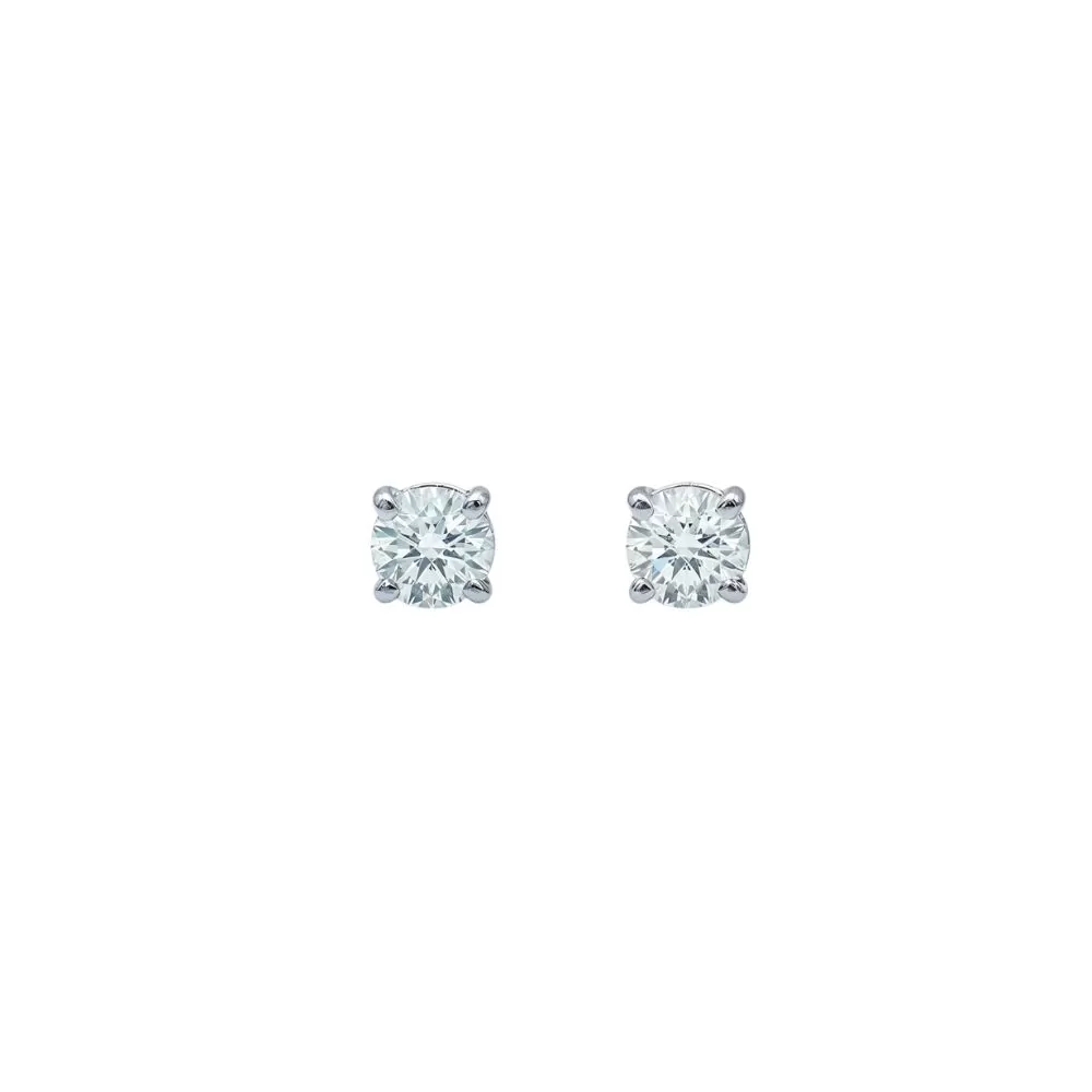 Aros solitarios en oro blanco con diamantes talla brillante (0.20 ct, color G-H, pureza VS2).