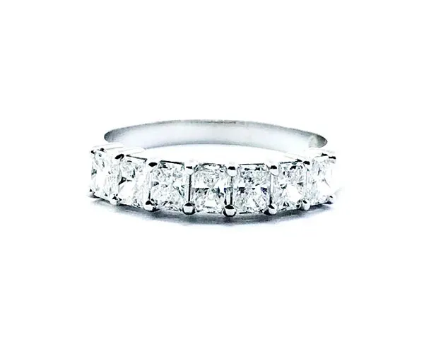Half eternity ring in platinum set with radiant-cut diamonds.