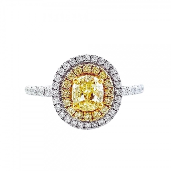 Engagement ring in white gold set with oval-cut Fancy Yellow diamond (0.703 ct).