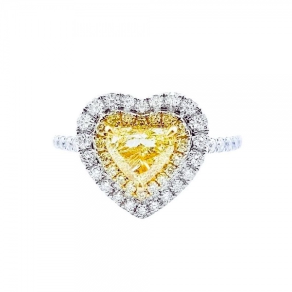 Ring in white gold set with heart-cut Fancy Yellow diamond and brilliant-cut Fancy Yellow and colorless diamonds. (total 1.201 ct)