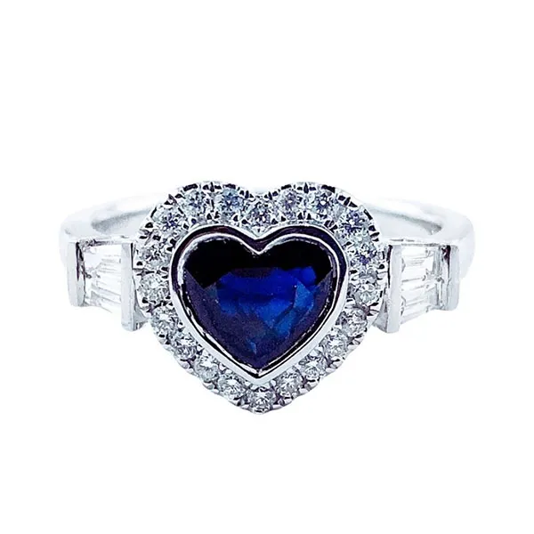 Ring in white gold set with heart-cut sapphire and baguette-cut and brilliant-cut diamonds.